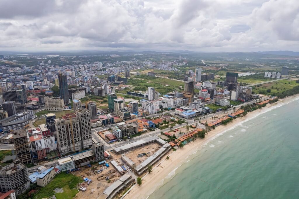 Expansive aerial view capturing Sihanoukville's cityscape and coastline in Cambodia.